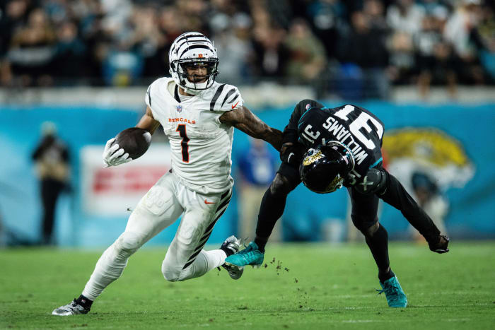 Dec 4, 2023; Jacksonville, Florida, USA; Cincinnati Bengals wide receiver Ja'Marr Chase (1) runs the ball against Jacksonville Jaguars cornerback Darious Williams (31) in extra time at EverBank Stadium. Mandatory Credit: Jeremy Reper-USA TODAY Sports